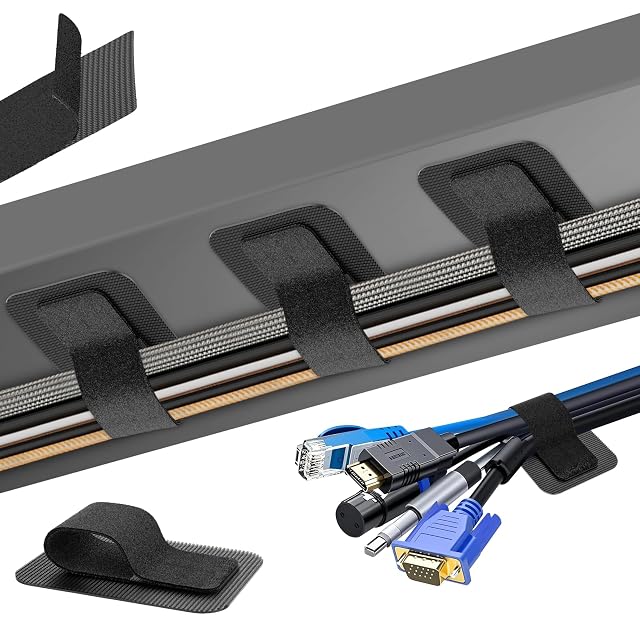 Black hook-and-loop cable straps with adhesive pads holding a bundle of cables under a desk
