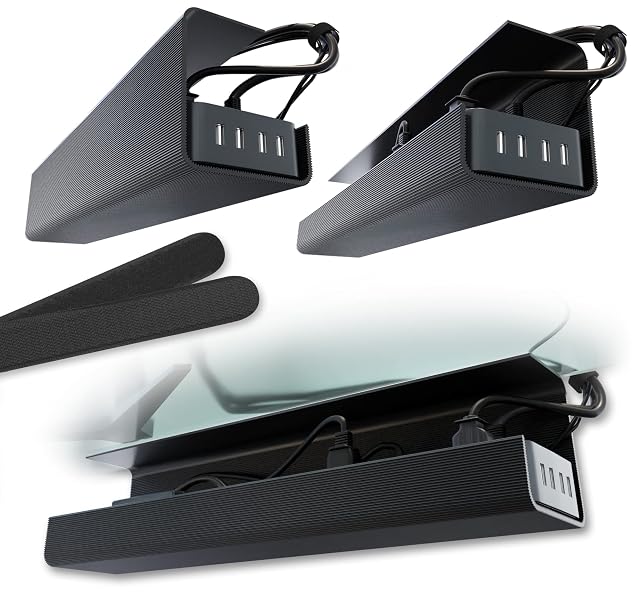 Two black adhesive-mounted under-desk cable trays holding a power strip