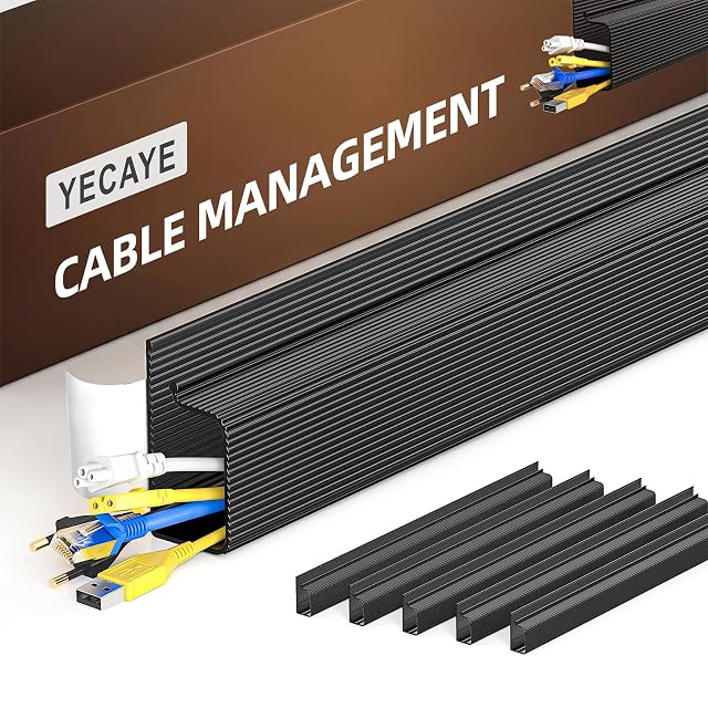Yecaye black J-channel cable raceway stuck under a desk with cables dropped into it