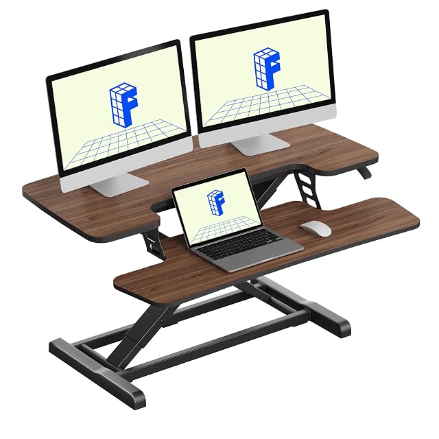 FLEXISPOT walnut 36 inch standing desk converter with a keyboard tray