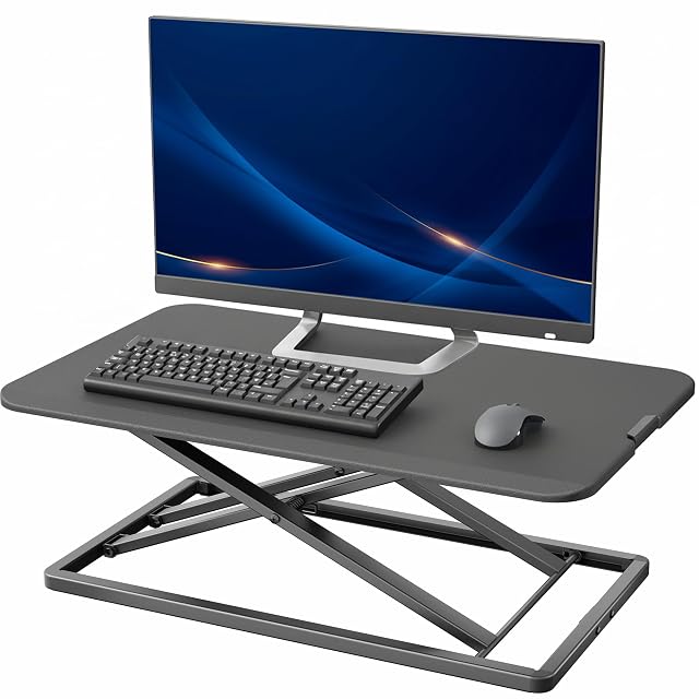 VIVO black single-top standing desk converter raised above a desk