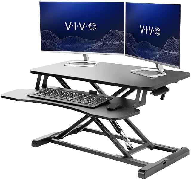 VIVO black 32 inch standing desk converter raised with a keyboard tray below